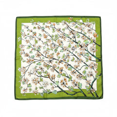 Silk scarf with colorful floral branch and butterfly motif on green background