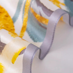 Silk square scarf close-up, yellow and white floral print with gray lines