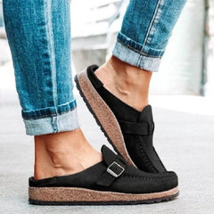 Black round-toe low-heel loafers with front buckle strap and textured trim