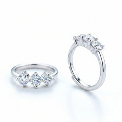 Sterling silver huggie hoop earrings with three round moissanite stones, side view