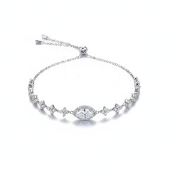 Sterling silver moissanite bracelet with oval clear center stone and blue-toned side stones