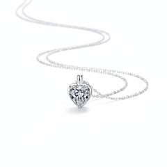 Heart-shaped moissanite pendant necklace in sterling silver with chain draped