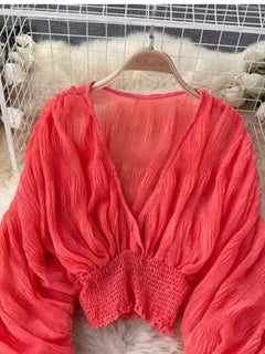 Orange smocked ruched V-neck long-sleeve blouse with gathered cuffs