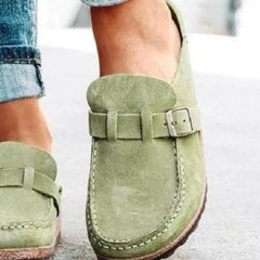 Sage green round-toe low-heel loafer with front buckle strap and side seam stitching