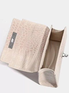 Off-white croc-embossed handbag open, showing fabric lining and interior