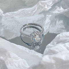 925 sterling silver ring with round center stone and pavé halo, angled view