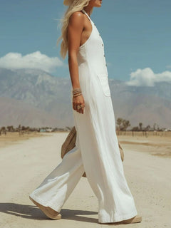 White halter neck wide-leg jumpsuit with front buttons and wide pant legs