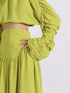 Green ruched long-sleeve crop top and high-waist skirt, gathered details at waist