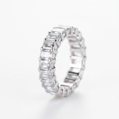 Rhodium-plated silver moissanite band ring with baguette-cut stones, side view.