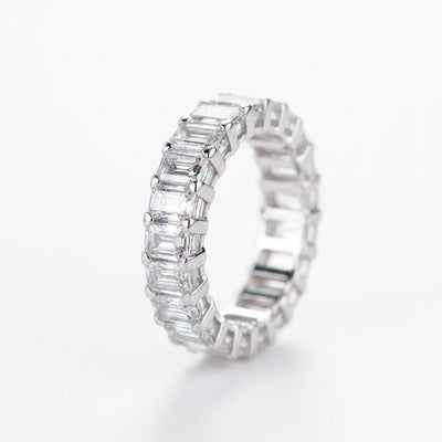 Rhodium-plated silver moissanite band ring with baguette-cut stones, side view.