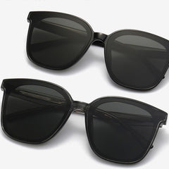 Oversized square sunglasses set with black frames and dark lenses