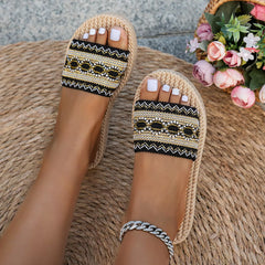 Open toe flat sandals with black-and-gold woven upper and round rope toe sole
