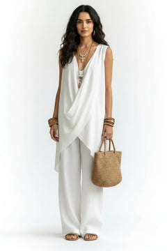 Sleeveless asymmetrical top and wide-leg pants set in white with draped crossover top