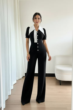Black wide-leg jumpsuit with short sleeves, white contrast front panel, and buttons