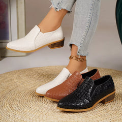 Point-toe block heel loafers in white, tan, and black with textured finish and gold chain.