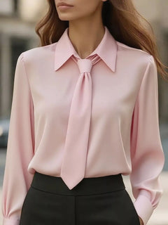 Pink collared long-sleeve blouse with neck tie bow at neckline