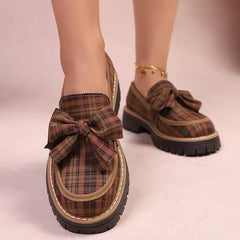 Plaid chunky loafers with large front bow, tan plaid upper and black sole