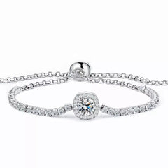 Silver tennis bracelet with round halo center stone and hinged-look clasp detail