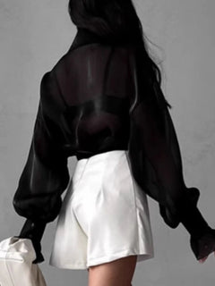 Black sheer button-up flounce sleeve shirt, back view with puff sleeves