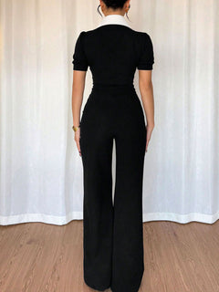 Black wide-leg jumpsuit with short sleeves and centered back seam