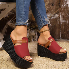 Open-toe wedge sandals with red and tan straps and black platform wedge heel