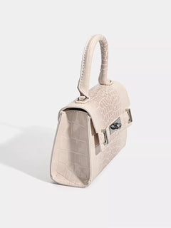 Off-white croc-embossed top-handle handbag, side view with strap