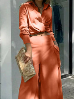 Rust orange wrap-style long-sleeve shirt with V-neck and belted waist