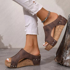 Dark brown open-toe wedge sandals with stud accents and cork-look wedge sole