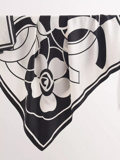 Square flower silk scarf close-up with black-and-white flower and geometric lines