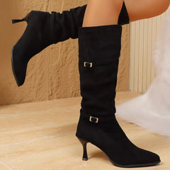 Black suede-like point-toe kitten heel boots with strap buckles at ankle
