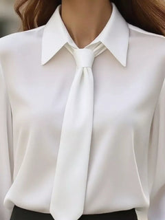 Close-up white blouse with pointed collar and neck tie