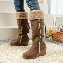 Brown wedge boots with fuzzy cuff and multiple buckle straps plus lace detail
