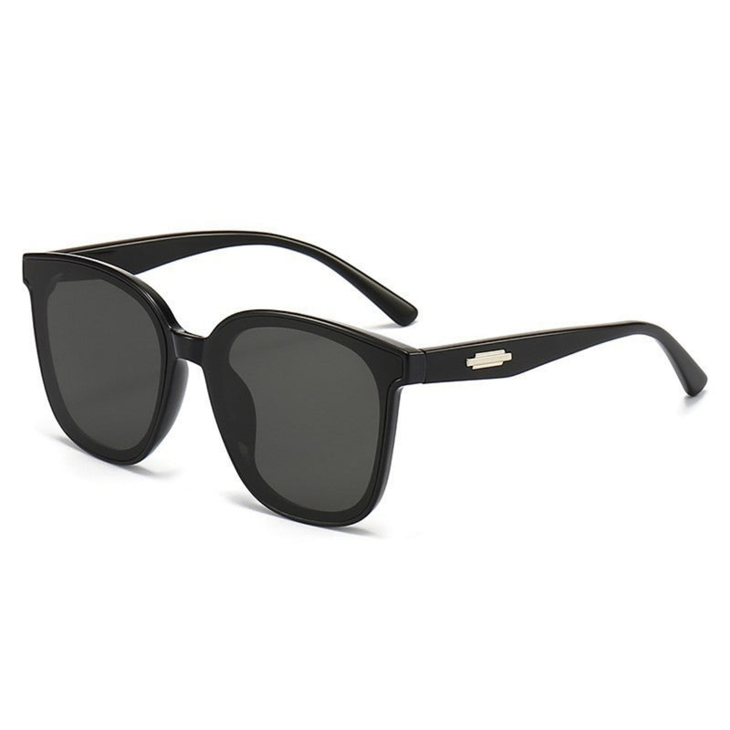 Oversized square sunglasses with black frames and dark lenses, gold bridge detail