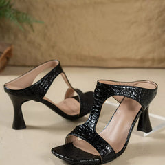 Black open-toe flare-heel sandals with crisscross straps and textured upper