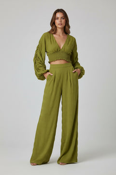 Olive green long-sleeve blouse with V-neck and ruched smocked waistband, loose sleeves
