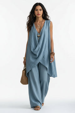 Sleeveless asymmetrical top and wide-leg pants set in blue, draped crossover front