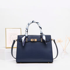Blue leather handbag with detachable shoulder strap and patterned scarf top handles