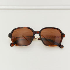 Brown tortoiseshell sunglasses with amber lenses and dark rounded temples