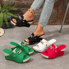 Open-toe wedge sandals set in black, green, beige, and red; gold chain buckles.
