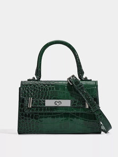Green croc-embossed top-handle handbag with front plaque and crossbody strap