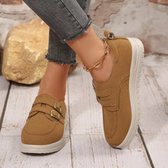 Tan suede buckle-accent casual loafers with double buckle straps and thick white sole