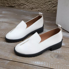 Pair of white round-toe block heel loafers with V-cut vamp and brown insoles